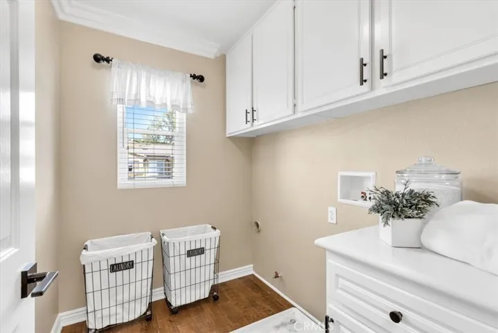The convenient upstairs laundry room is light & bright and includes loads of cabinets for all your stoarge needs.