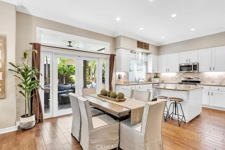 The dining area flows seamlessly between the kitchen and the living room, and French doors that open onto the beautiful back patio.