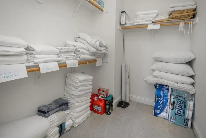 Walk-in closet complete w/ supplies for the vacation rental