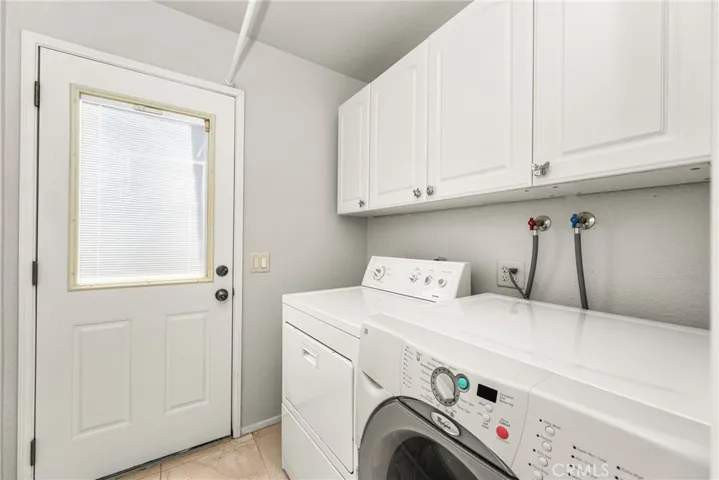 The Laundry room has a door to the backyard, and could be converted into a full bath by putting the laundry into the garage.