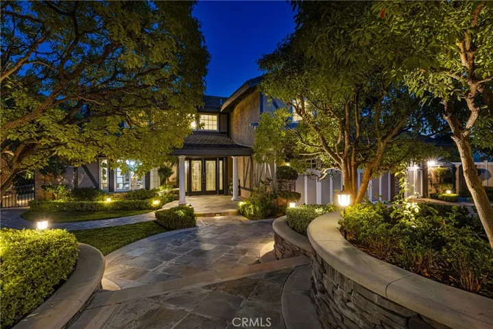 Custom landscape lighting throughout this half-acre property makes for stunning nighttime views.