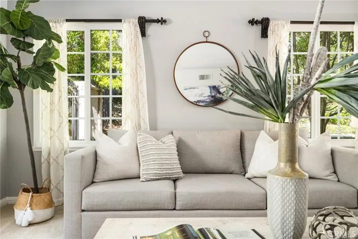 The forrmal living room features a bow front window, just perfect for holiday decorations, adn oversided windows flooding the room with light.