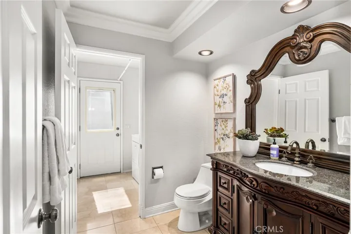 The downstairs bath is open to the laundry room.