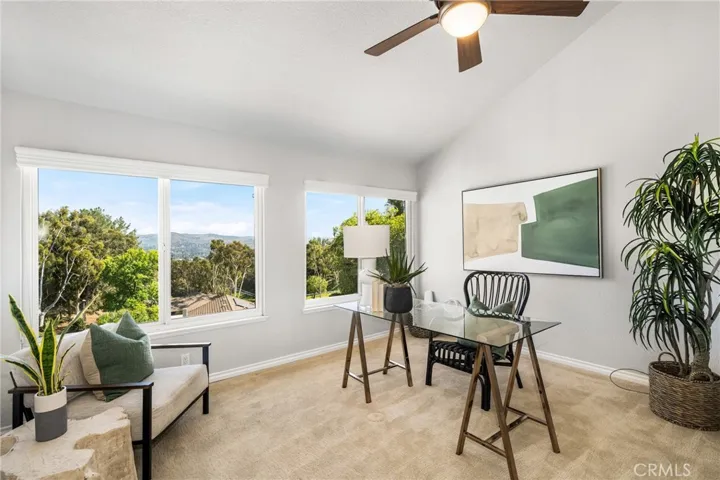 There are four more bedrooms upstairs, including this one currently used as an office, three of which have views of the backyard.