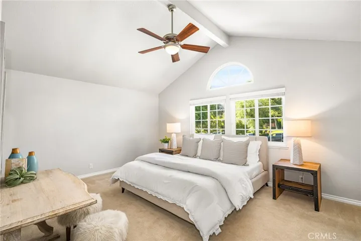 The oversized primary suite features cathedral ceilings and oodles of natural light.