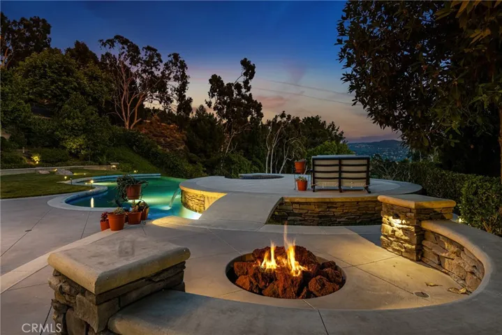 Or enjoy your fire pit, surrounded by a built-in bench. The hardscape on this home is exceptional.