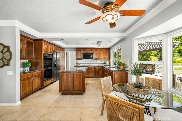 The chef's kitchen features custom cabinetry, upgraded appliances and granite counters, and a brand new Frigidare Gallery 2680 cooktop.