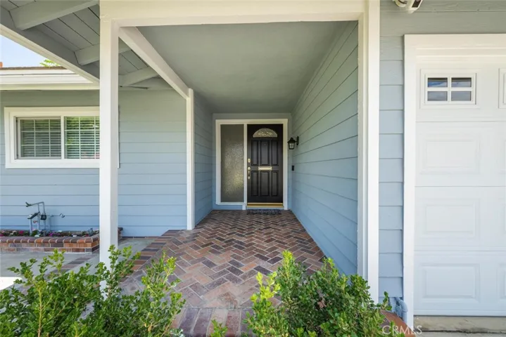 Accented with a handsome entry door and a touch of masonry work adds a nice toucht to complete the look.