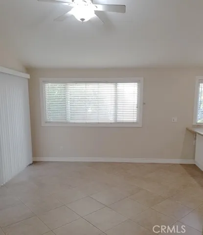 Family room open to the kitchen, ceiling fan, and sliding glass doors to the back yard.