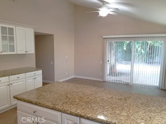 Beautiful kitchen tile flooring, granite counters, travertine backsplash, and a butler's pantry