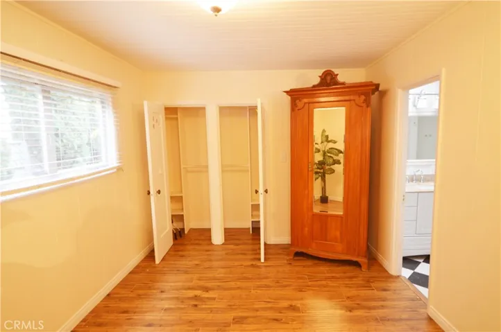 The secondary bedroom closets.  This bedroom's private bath is to the right.