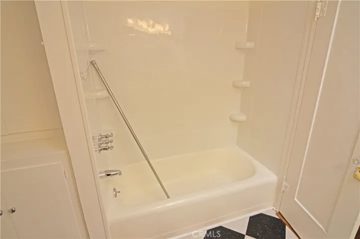 The secondary bathroom's tub and shower.  (Excuse the shower curtain rod!)