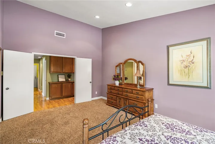 View of primary bedroom with double door entry to Hall