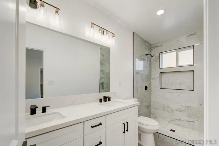 MASTER BATHROOM WITH DUAL SINKS AND TILE SHOWER