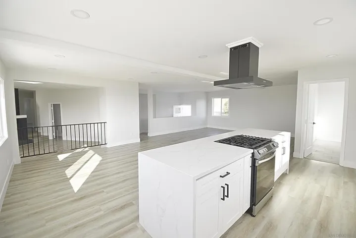 OPEN KITCHEN WITH ISLAND AND WATER FALL COUNTER TOPS
