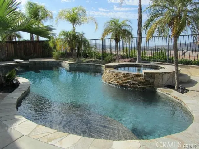 Pool with waterfall-feature spa.