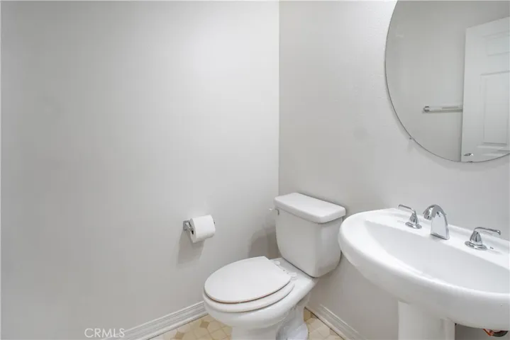 Half Bath on first floor adjacent to the separate Laundry room. Washer and Dryer are to remain.