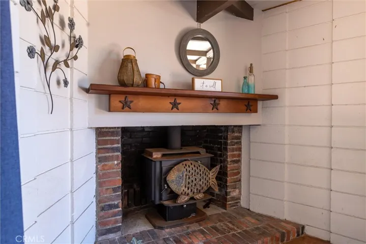 Warm and rustic fireplace and mantel in the Living / Dining area