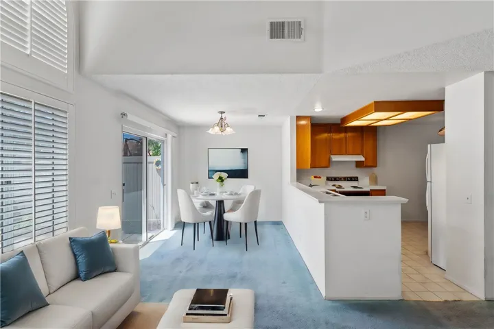 Kitchen opens to family room. Virtually staged