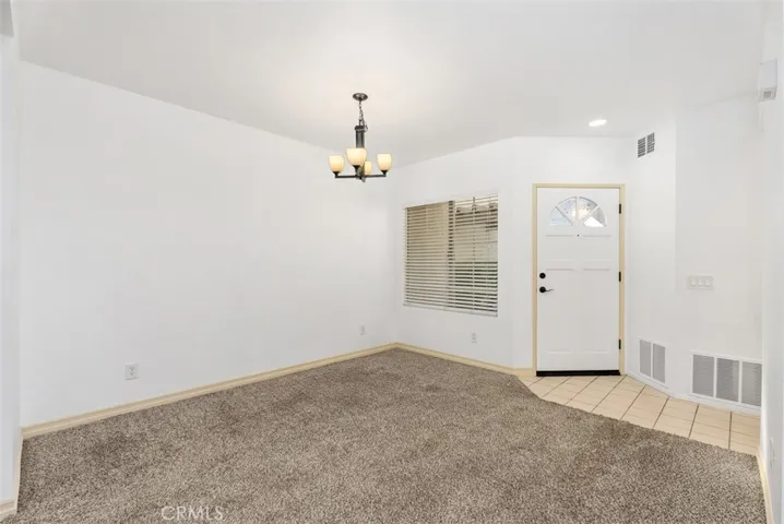 View from the stairs to the dining area and front door