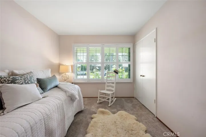 Bedroom #2. Wood floors under carpet.