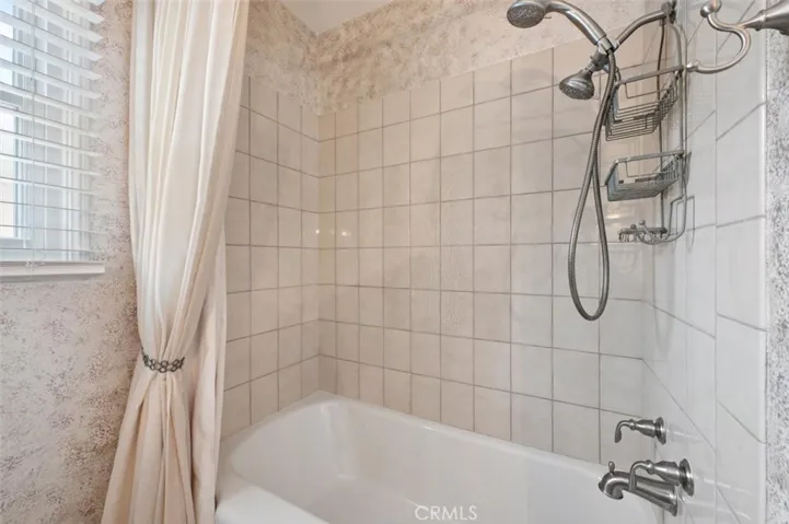 Tub and shower in hall bath.