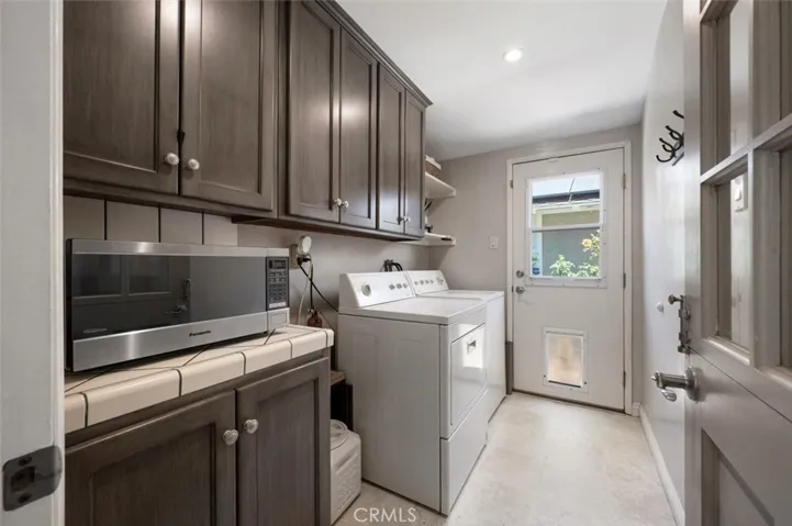 Large laundry room with doggie door.
