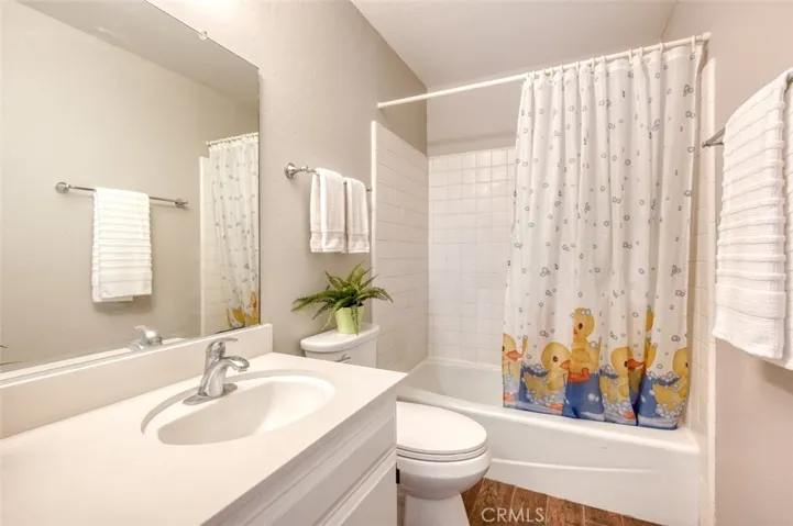 Full size hall bath with shower in bathtub.