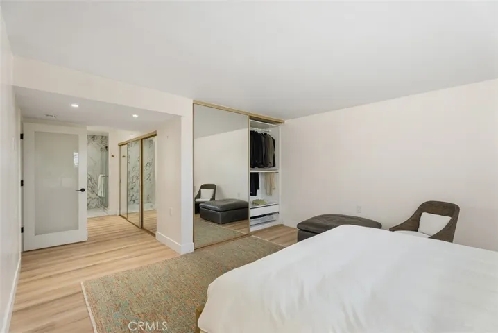 Another view of the mirrored wardrobes with custom closet organizers.