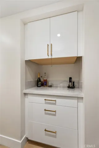 Dry Bar with great storage cabinets in hallway off of kitchen area.