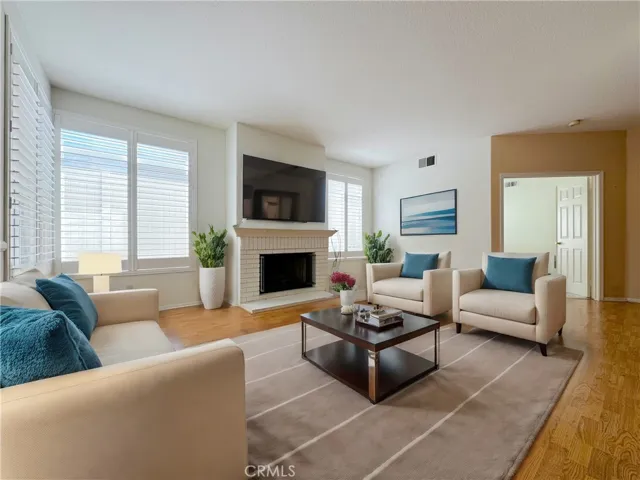 Family room with cozy fireplace. Virtually Staged