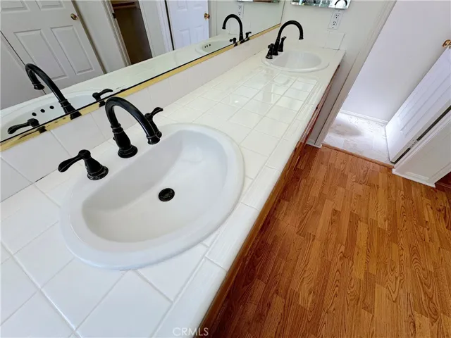 Primary bathroom with double sinks and cool tile