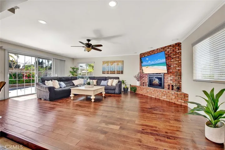 Over 400 Square Foot Family Room Addition with Hardwood Flooring and Brick Fireplace with Raised Hearth