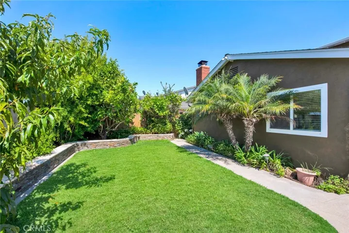 Wrap-Around Backyard with Lush Lawn