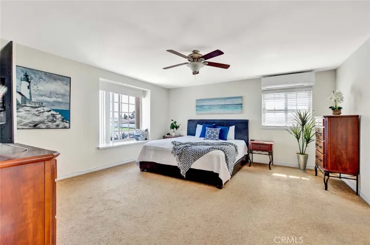 Primary Suite has Retreat Sitting Area, Window Seat, Ceiling Fan, French Dual Pane Windows, and Remodeled Ensuite Bathroom