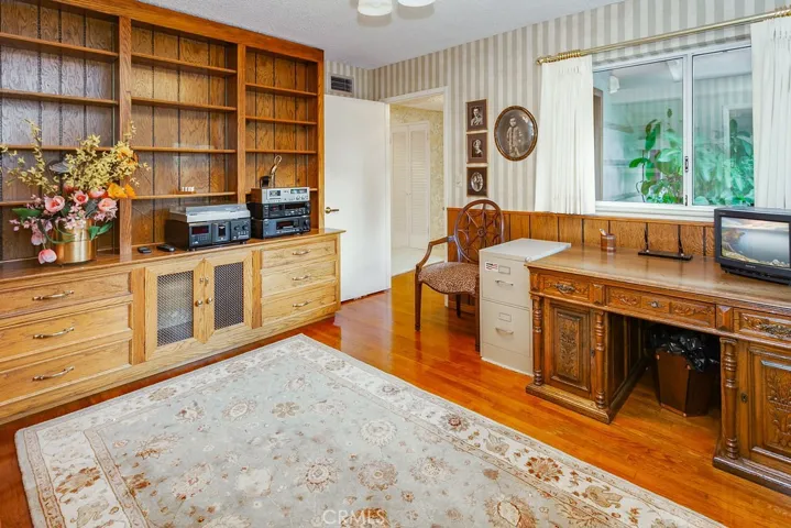 2 additional bright and airy bedrooms. One bedroom with built-in shelving, ample closet space to maximize storage, mirrored wardrobe doors and plush wall-to-wall carpet. The additional bedroom is enriched with custom built-in oak shelving and storage, wainscoting, a walk-in closet and gleaming oak hardwood floors; also perfect as a private office or den.