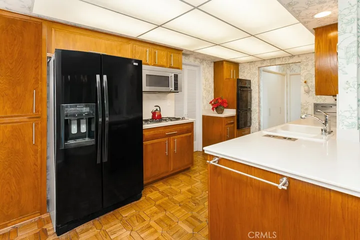 The cook in the family is going to truly appreciate the open and bright kitchen with its rich solid oak cabinetry, pots and pans drawers, full extension drawers, Corian countertops, dual basin sink, JennAir stainless-steel 5-burner gas cooktop, JennAir stainless-steel microwave oven, Maytag double oven, dishwasher, in-wall stainless-steel toaster, in-counter mixer and blender, handy pantry plus an additional walk-in pantry, water purifier and Monticello pattern solid oak parquet floors.