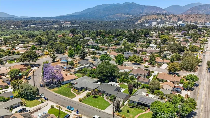 View to the northwest. House in forefront next to house with Jacaranda Tree.