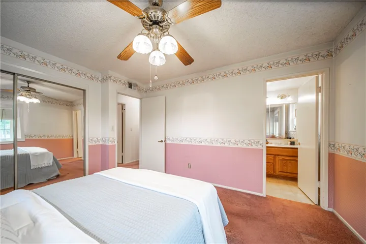 The primary bedroom has mirrored closet doors, and its own private bathroom.