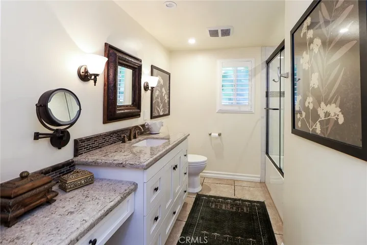 Remodeled Full Hall Bath, granite counter tops  vanity and make up vanity, tile floors, glass shower enclosure. Deep soaking tub. recessed lighting