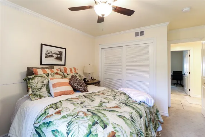Second bedroom. Custom closets with louvered doors and built in shelves.