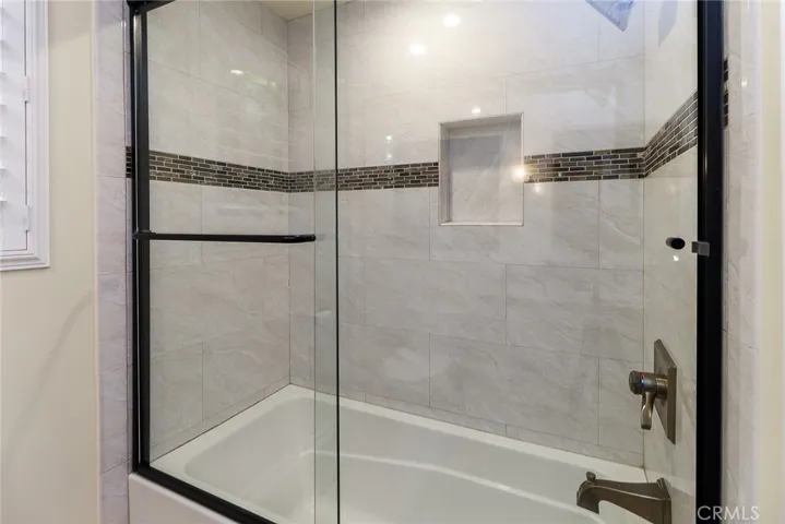 Glass enclosed shower and deep soaking tub.