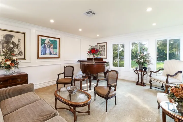 Bright and airy living room gorgeous view of park like private front yard. Newer windows throughout home. recessed lighting. Wainscoting.