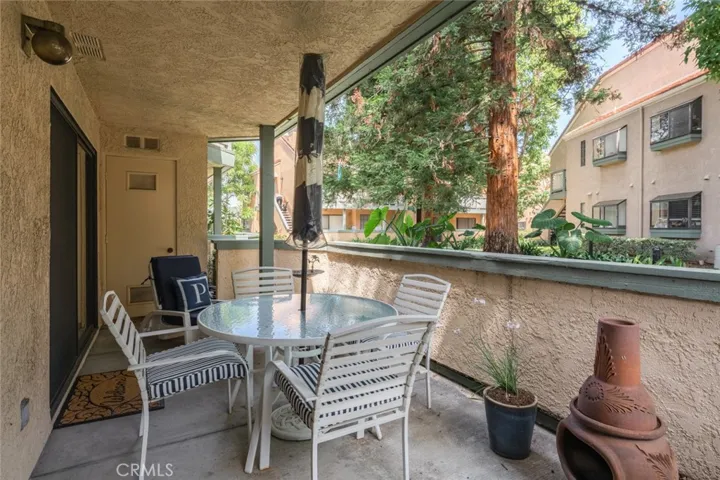 Wonderful covered patio surrounded be beautiful trees and greenery