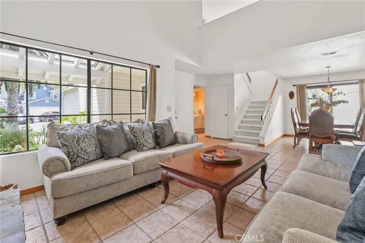 The view of the dining room from the living room. The half bathroom can be seen on the far left side of the staircase.