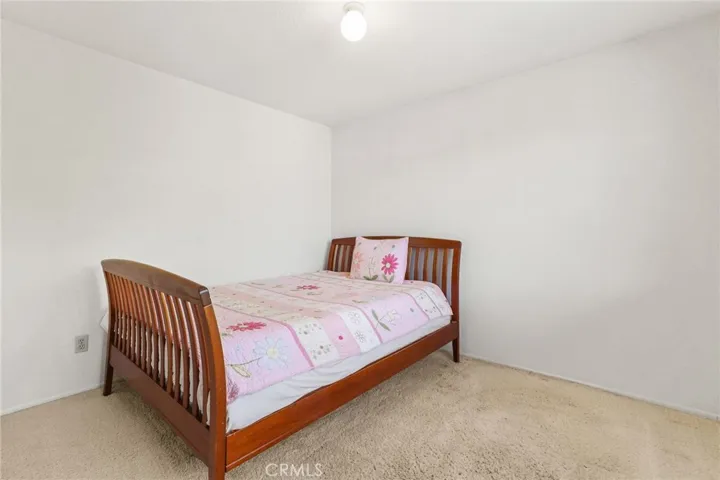 The second bedroom with carpeted floor.