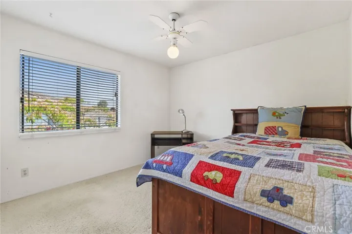 The third bedroom with ample space and a window looking into the backyard.