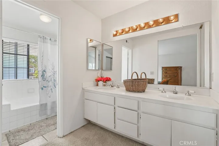 The primary bathroom has an oversized oval tub/shower combo.
