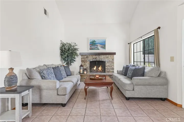 The living room with a Cathedral ceiling and beautiful fireplace remodeled less than 10 years ago.