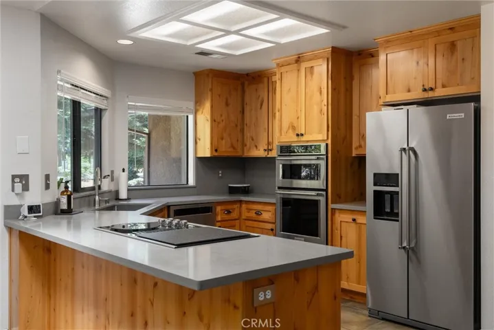 Kitchen with solid surface counters and stainless appliances